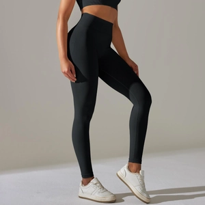 Side view of black high-waisted seamless yoga pants with textured sweat-wicking fabric