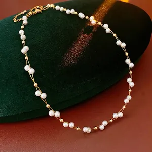 French vintage double-layered pearl and gold bead necklace on green velvet stand