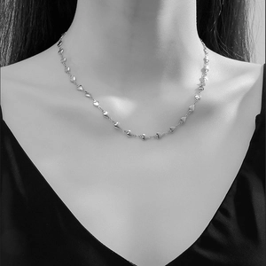 Close-up of heart-shaped link chain necklace on model for elegant styling