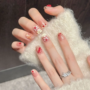Handmade lion dance press-on nails in pink and red with festive glitter and heart patterns