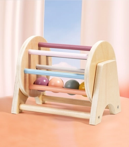Macro view of Montessori spinning drum featuring colorful wooden rods and interior balls