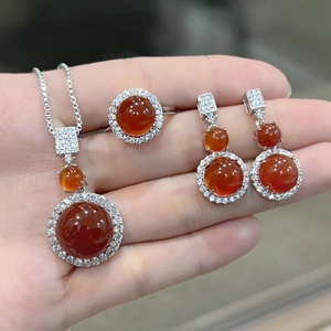 Detailed view of red chalcedony jewelry set including necklace, ring and earrings