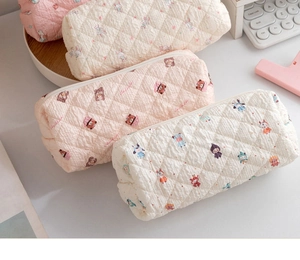 Detailed view of quilted cotton pouches featuring cute cartoon rabbits and bear prints