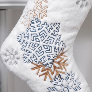 White faux rabbit fur Christmas stocking with embroidered snowflakes in gold and silver
