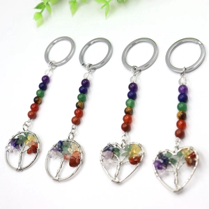 Detail of colorful chakra natural stone tree of life pendants in round and heart shapes