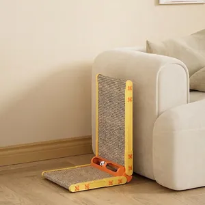 L-shaped sisal scratching board with built-in ball toy against a beige fabric sofa