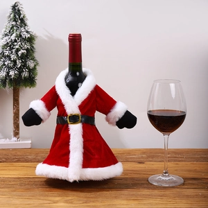 Close-up of festive red plush wine bottle cover with a belt on a wooden table decoration