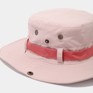 Detail of pink boonie hat with red webbing, metal eyelets, and reinforced stitching