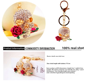 Detailed view of skull and red rose keychain with sparkling rhinestones and gold finish