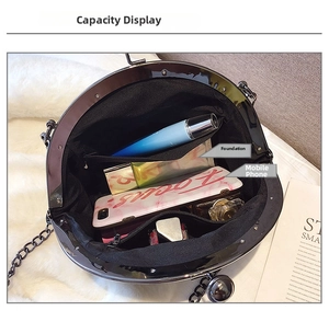 Detail view of the black metal shell bag interior showing storage for phone and perfume