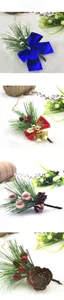Close-up of assorted Christmas pine needles with festive bows, bells, and pinecones decorations