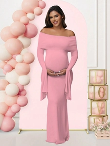 Detailed view of pink off-shoulder maternity evening gown for baby shower photoshoot