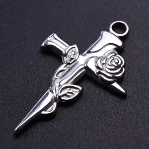 Detail of 304 stainless steel cross pendant wrapped with rose and leaf on black background