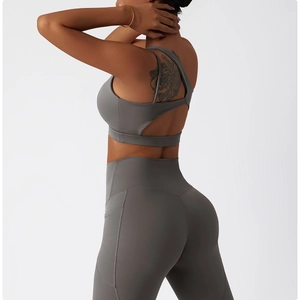 Detailed side-back view of dark grey yoga set with cutout sports bra and side pockets