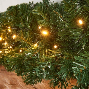 Green PVC Christmas garland with warm white LED lights for festive door and wall decor