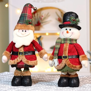 Detail of Santa and Snowman plush toys with knitted outfits and festive plaid accessories
