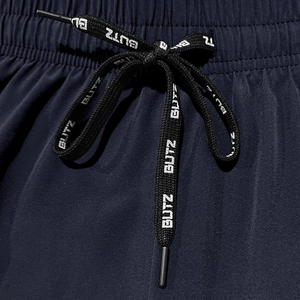 Detail of dark blue quick-dry fabric with elastic waistband and BUTZ printed drawstring