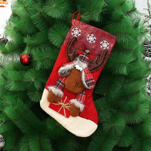Large red Christmas stocking with plush reindeer and snowflake patterns for tree decoration