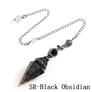 Macro view of black obsidian crystal pendulum with antique silver cap and copper wire wrap