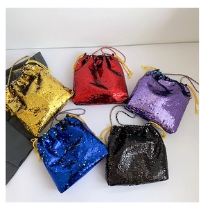 Close-up of five colorful sequin drawstring bucket bags in gold, red, blue and black