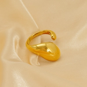 Minimalist golden titanium steel irregular liquid droplet ring on champagne silk background