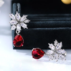 Sparkling flower-shaped stud earrings with pear-cut red zircon teardrops and silver finish