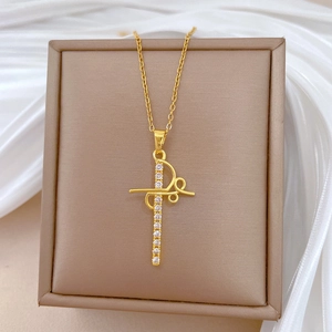Close-up of a luxury gold-plated hollow cross necklace with sparkling rhinestones