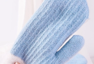 Close-up of light blue chunky knit mittens with soft pink plush wrist cuffs detail