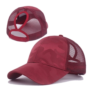 Detail of burgundy camo mesh baseball cap featuring a functional ponytail hole design