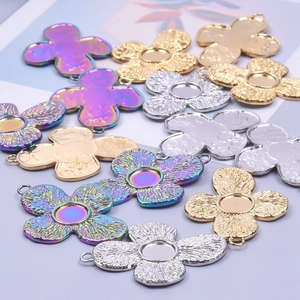 Set of 10 vintage palace style clover pendants in gold, silver, and iridescent finishes