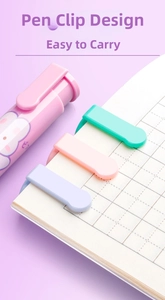 Detail view of macaron-colored retractable erasers with clip on grid paper notebook
