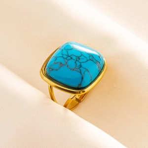 Detailed close-up of a vintage adjustable gold ring with a square blue turquoise stone