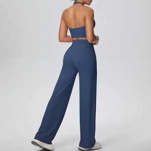 Detail view of the back-less halter yoga top and high-waist wide-leg pants in navy blue