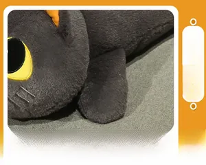 Detailed view of black plush cat pillow with soft filling and yellow embroidered eyes