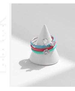 Detail of three-piece S925 silver stacked rings with colorful enamel and zircon stones