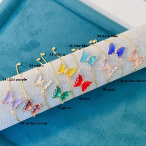 Selection of colorful butterfly charms on adjustable 18K gold-plated jewelry stand