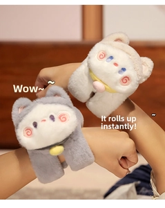 Detail of plush cat snap bracelet showing soft grey and white fabric with bell charms
