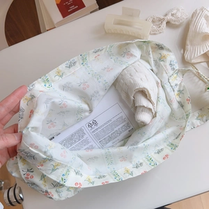 Detailed view of floral cotton tote bag with product information card and accessories