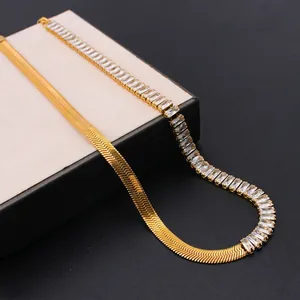 Detail of 18k gold plated flat snake chain joined with baguette cut cubic zirconia