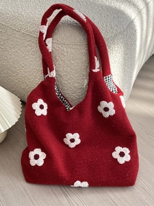 Red plush floral tote bag with white flower embroidery and black checkered lining