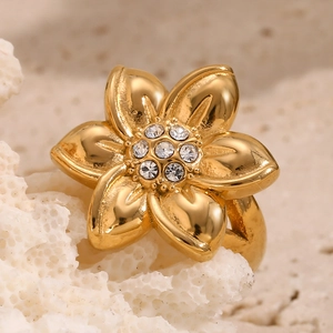 Macro shot of 18K gold plated floral ring featuring sparkling crystal cluster on coral stone