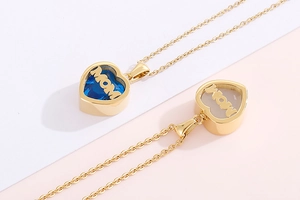 Detail of gold heart necklaces with blue and white birthstones and MOM inscription