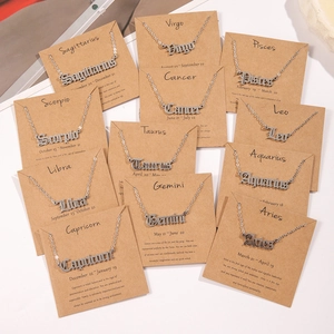Set of 12 silver-toned Old English zodiac necklaces on brown cards with character descriptions