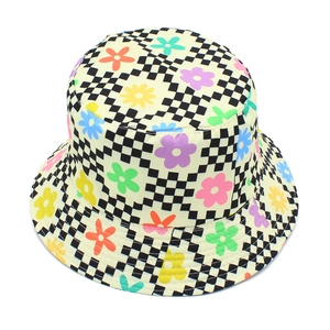 Macro shot of colorful floral pattern on black and white checkerboard bucket hat fabric
