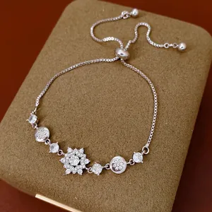 Elegant silver snowflake bracelet with zircon stones and adjustable box chain on jewelry box