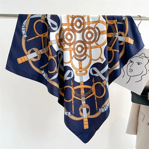 Macro detail of high-quality silk scarf with classic horse harness and chain print