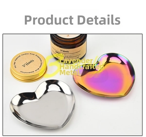 Close-up of heart-shaped stainless steel tray with perfume candle on white background