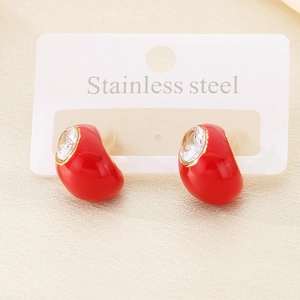 Detail of teardrop earrings with red enamel finish and sparkling crystal studs