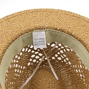 Detail view of the interior sweatband and 100% paper material label on the raffia sun hat