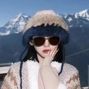 Close-up of winter knit earflap hat with plush fur lining and woven cords on snowy background